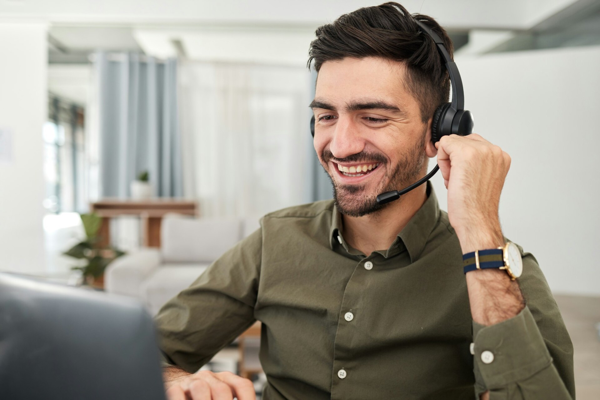 Office worker with headphones denoting VoIP communication