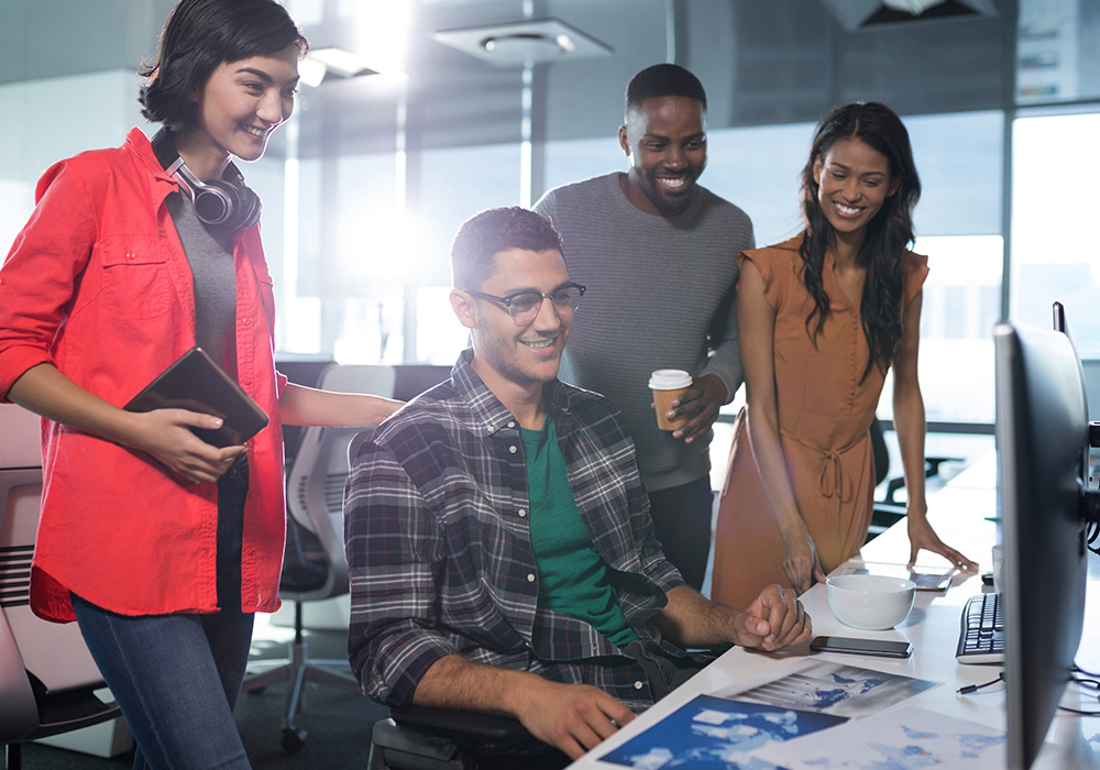 Colleagues around a screen introducing our small business service package